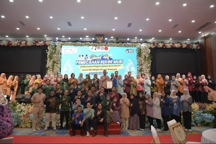 Foto bersama tim dan peserta pada panggung kegiatan.